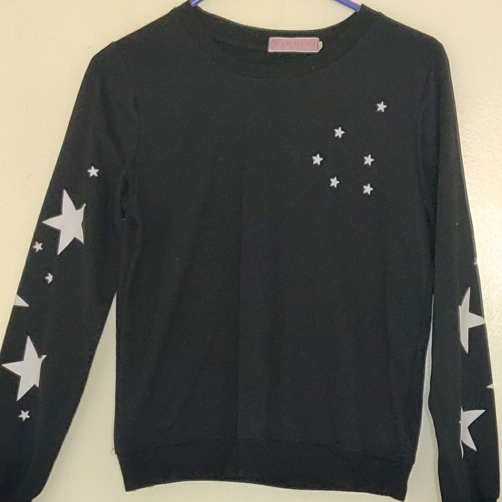 Black sweater with white stars